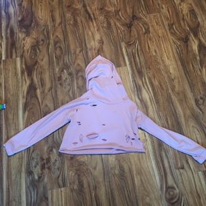 pink cropped hoodie, hood strings are missing.